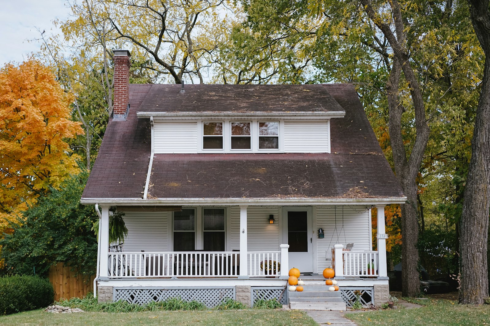 A brick house with a gable roof and a brick chimney